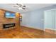 Cozy living room with wood-paneled wall, electric fireplace, and hardwood floors at 1139 Princeton Kenly Rd, Kenly, NC 27542