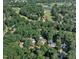 Expansive aerial view of a residential area near Prestwood Golf Course, surrounded by lush greenery and serene lakes at 115 E Seve Ct, Morrisville, NC 27560