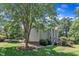The exterior view showcases a spacious backyard with lush landscaping, a deck, and greenery at 115 E Seve Ct, Morrisville, NC 27560