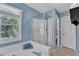 Bathroom featuring a separate shower, large tub, and window with backyard view at 115 E Seve Ct, Morrisville, NC 27560