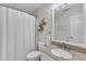 Bathroom with granite countertop vanity, framed mirror, and tiled shower with curtain at 115 E Seve Ct, Morrisville, NC 27560