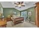 Bedroom with a cozy bed, ceiling fan, and natural light from the windows at 115 E Seve Ct, Morrisville, NC 27560