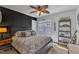 Inviting bedroom with dark accent wall, window with blinds, and stylish decor at 115 E Seve Ct, Morrisville, NC 27560