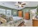 Comfortable bedroom featuring a bed with decorative pillows, ceiling fan, and closet at 115 E Seve Ct, Morrisville, NC 27560