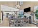 Bright dining area featuring a wood table, white chairs, a fireplace, and an open-concept kitchen at 115 E Seve Ct, Morrisville, NC 27560