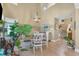 Bright dining area featuring a wood table, white chairs, a modern chandelier, and hardwood floors at 115 E Seve Ct, Morrisville, NC 27560