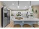 Modern kitchen with stainless steel appliances, white cabinetry, quartz countertops, and stylish pendant lighting at 115 E Seve Ct, Morrisville, NC 27560