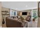 Comfortable living room featuring a large leather sofa, natural light and stylish decor at 115 E Seve Ct, Morrisville, NC 27560