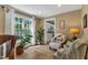 Cozy living room with hardwood floors, large windows, comfortable seating, and a bright, inviting atmosphere at 115 E Seve Ct, Morrisville, NC 27560