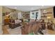 Spacious living room featuring a large brown leather sofa, natural light, and stylish decor at 115 E Seve Ct, Morrisville, NC 27560