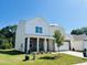 Charming two-story home featuring a brick and white siding exterior, a well-manicured lawn and attached garage at 140 N Keatts Winner Ct, Wilson's Mills, NC 27520
