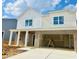 Two-story home featuring brick and vinyl siding, white trim, and an attached two car garage at 140 N Keatts Winner Ct, Wilson's Mills, NC 27520