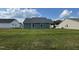 Back exterior of home from the yard on a sunny day with blue sky at 140 Oakfield Trace Dr, Four Oaks, NC 27524