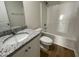 Bright bathroom with granite vanity and shower-tub combination at 140 Oakfield Trace Dr, Four Oaks, NC 27524