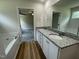 Bathroom with double sinks, granite countertop, soaking tub, and a view to the bedroom at 140 Oakfield Trace Dr, Four Oaks, NC 27524