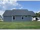 Back exterior of home from the yard on a sunny day with blue sky at 140 Oakfield Trace Dr, Four Oaks, NC 27524