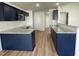 Modern kitchen features granite countertops, stainless steel appliances, and navy blue cabinets at 140 Oakfield Trace Dr, Four Oaks, NC 27524