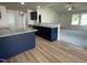 Open concept kitchen with a view to the living room, granite countertops, and navy blue cabinets at 140 Oakfield Trace Dr, Four Oaks, NC 27524