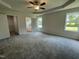 Spacious main bedroom featuring plush carpeting, abundant natural light, and a closet at 140 Oakfield Trace Dr, Four Oaks, NC 27524