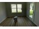Neutral room showing wood-look flooring, window with view, and access to the exterior at 140 Oakfield Trace Dr, Four Oaks, NC 27524