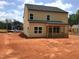 View of the back of the house featuring an unfinished porch overlooking a large backyard at 1413 Malcus Ct # 61, Fuquay Varina, NC 27526