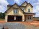 New two-story home featuring a two-car garage and a classic facade at 1413 Malcus Ct # 61, Fuquay Varina, NC 27526