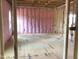 View of an unfinished room with framed walls and pink insulation ready for customization and design at 1413 Malcus Ct # 61, Fuquay Varina, NC 27526