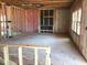 An unfinished living room with framed walls, pink insulation, and fireplace inset ready for customization at 1413 Malcus Ct # 61, Fuquay Varina, NC 27526