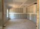 Bright living room with drywall, rough electrical, and two windows at 1413 Malcus Ct # 61, Fuquay Varina, NC 27526