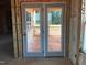 Access to the unfinished outdoor patio, visible through glass doors awaiting its transformation at 1413 Malcus Ct # 61, Fuquay Varina, NC 27526