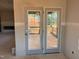 Patio doors lead to a cozy outdoor space with a wooden railing, perfect for relaxation and entertainment at 1413 Malcus Ct # 61, Fuquay Varina, NC 27526