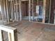An unfinished interior space with visible wall framing and a glimpse into the bathroom layout at 1413 Malcus Ct # 61, Fuquay Varina, NC 27526