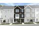 Charming townhouse showcasing a stone facade, a covered entryway and manicured landscaping for enhanced curb appeal at 1424 Jay Rd, Knightdale, NC 27545