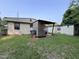 Backyard view of the home with detached structures and a well-maintained lawn at 1521 Lewis St, Rocky Mount, NC 27804