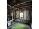 Interior with exposed studs, wooden floor, and cinder block foundation at 1521 Lewis St, Rocky Mount, NC 27804