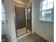 Bathroom shower with glass door and window bringing in natural light at 1577 Goldfinch Perch Ln, Knightdale, NC 27545