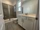 This bathroom features a tiled shower, a white vanity, and gray floors at 1577 Goldfinch Perch Ln, Knightdale, NC 27545