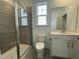 Well-lit bathroom with tiled shower, toilet, and vanity with a large mirror at 1577 Goldfinch Perch Ln, Knightdale, NC 27545