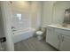 Bright bathroom with white tub, toilet, and single vanity at 1577 Goldfinch Perch Ln, Knightdale, NC 27545