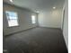 Spacious bedroom with carpet flooring and windows for natural light at 1577 Goldfinch Perch Ln, Knightdale, NC 27545