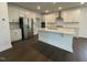 Modern kitchen boasts stainless steel appliances, a central island, and crisp white cabinetry for a clean look at 1577 Goldfinch Perch Ln, Knightdale, NC 27545