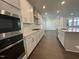 Well-equipped kitchen with stainless steel appliances, ample counter space, and sleek white cabinets for storage at 1577 Goldfinch Perch Ln, Knightdale, NC 27545