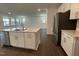 Well-appointed kitchen with stainless steel appliances, white cabinets, and a kitchen island at 1577 Goldfinch Perch Ln, Knightdale, NC 27545