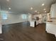 Expansive living area with sleek hardwood floors seamlessly connects the kitchen, dining, and living spaces at 1577 Goldfinch Perch Ln, Knightdale, NC 27545