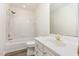Clean bathroom with shower-tub combo, neutral tile and flooring, updated vanity and fixtures at 1613 Patterson Grove Rd, Apex, NC 27502