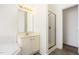 Bathroom showcasing vanity with gold fixtures, framed mirror, and glass door shower at 1613 Patterson Grove Rd, Apex, NC 27502