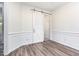 Bedroom with gray walls, hardwood flooring, and sliding barn door at 1613 Patterson Grove Rd, Apex, NC 27502