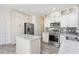 Bright kitchen with stainless steel appliances, island, and white cabinets at 1613 Patterson Grove Rd, Apex, NC 27502