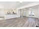 Bright, open-concept living area with hardwood floors flowing into a modern kitchen at 1613 Patterson Grove Rd, Apex, NC 27502