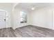 Spacious living room with wood-like flooring, abundant natural light, and a view of the home's exterior at 1613 Patterson Grove Rd, Apex, NC 27502